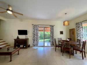 - un salon avec une table et une télévision dans l'établissement Costa Riki Apartments, à Santa Teresa
