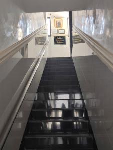 an escalator in a building with a person on it at Hôtel Assaâda in Rabat