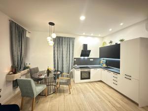 a kitchen and living room with a table and chairs at V Apartment in Šibenik
