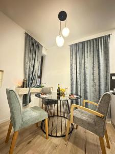 a living room with a table and two chairs and a dining room at V Apartment in Šibenik