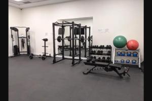 a gym with several squat racks and weights at Comfy Condo Near Downtown in Kitchener