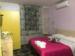 a bedroom with a bed with towels on it at B&B L'Alba in Gagliato