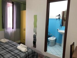 a bathroom with a bed and a sink and a mirror at B&B L'Alba in Gagliato +55 photos