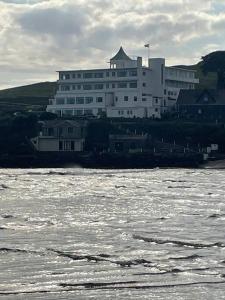 a large white building next to a body of water at Bumble Bee Cottage in Plymouth +40 photos