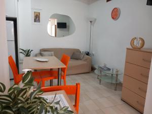 a living room with a table and chairs and a couch at Studio Victory Chania in Chania