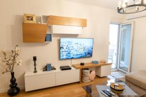 a living room with a flat screen tv on a wall at Luxury AMAAA Apartment in Bar