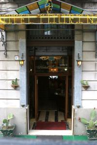 a entrance to a building with a sign on it at Hotel Touring in Messina