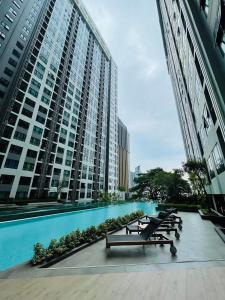 a row of benches in front of a large building at The base Central Pattaya 631 by Numam in Pattaya