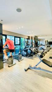 a man exercising in a gym with cardio machines at The base Central Pattaya 631 by Numam in Pattaya
