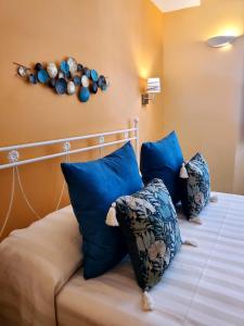 a bedroom with a bed with blue pillows at Residenza FillAnfi in Lucca