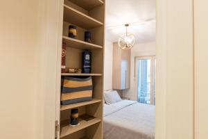 a bedroom with a bed and a closet with shelves at Luxury AMAAA Apartment in Bar
