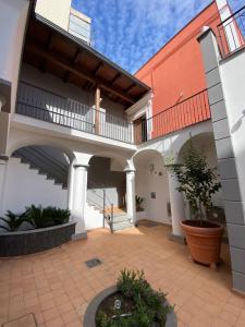 a courtyard of a house with a balcony and a staircase at Zara Palace in Scafati
