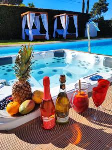 a tray of fruit and drinks next to a swimming pool at Villa Whiteloft Pool Spa Lounge in Corroios