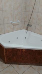 a bath tub with a faucet in a bathroom at DORMI-con HIDROMASAJE- POSADA RUTA 22 totalmente EQUIPADO in Plottier