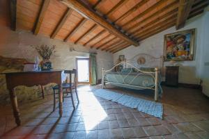 a bedroom with a bed and a table in a room at Agriturismo La Colombella in Bagni San Filippo +73 photos