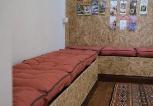 a row of red pillows sitting in a room at @Home Hostel Wua Lai in Chiang Mai