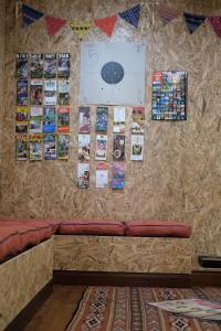 a wall with a couch with pictures on it at @Home Hostel Wua Lai in Chiang Mai