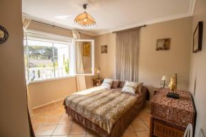 a bedroom with a bed and a window at Superbe villa accès direct plage in Saint-Raphaël +18 photos