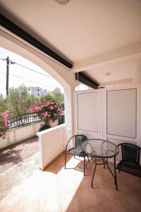 a patio with a table and chairs on a balcony at Apartments Marina in Petrcane