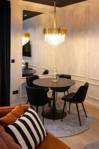 a dining room with a table and chairs and a chandelier at Candy Ballerina No 3 Zagreb Center - top positon Lux in Zagreb