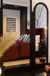 a mirror in a bedroom with a bed and a dresser at Candy Ballerina No 3 Zagreb Center - top positon Lux in Zagreb