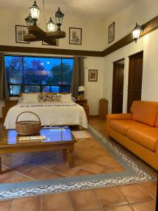 1 dormitorio con cama, sofá y mesa en La Pedrera Atlixco, 