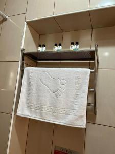 a towel on a towel rack in a bathroom at Akar Pansiyon in Çanakkale