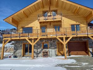 a large wooden house with a large deck at Eco-Logis des Cabris in Font-Romeu