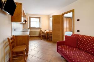 a kitchen and living room with a couch and a table at Chalet Anna Cigambola in Livigno