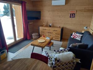 a living room with a couch and a table at Eco-Logis des Cabris in Font-Romeu