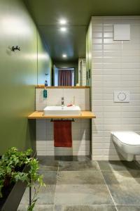 a bathroom with a sink and a toilet at ipartment Berlin Airport in Schönefeld