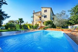 ein Pool vor einem Haus in der Unterkunft Apartments with pool Albina in Umag