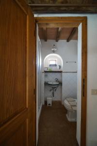 a small bathroom with a toilet and a sink at Agriturismo La Colombella in Bagni San Filippo
