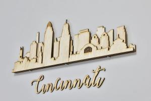 a wooden sign for a hotel with a skyline at **NEW RADiant Stay in the Thrust of OTR* w/Parking in Cincinnati