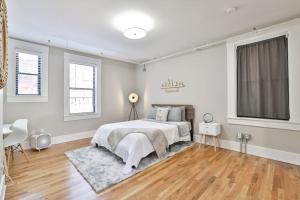 a white bedroom with a bed and a wooden floor at **NEW RADiant Stay in the Thrust of OTR* w/Parking in Cincinnati