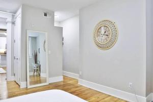a white room with a clock on the wall at **NEW RADiant Stay in the Thrust of OTR* w/Parking in Cincinnati