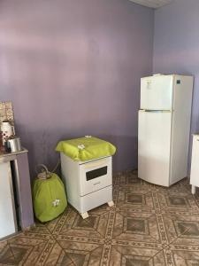 a kitchen with a refrigerator and a stove and a microwave at Chalé Agreste in Santana do Riacho