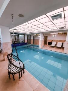 a swimming pool with a swing in a building at Утро без Аларма, Смолянски езера. Alarm free Morning Smolyan lakes in Smolyan