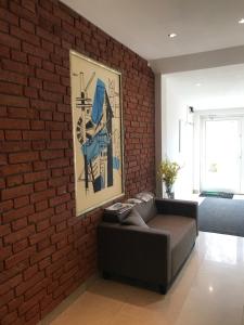 a brick wall in a living room with a couch at Fabryka in Sopot
