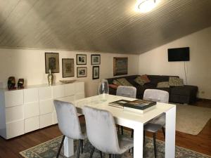 een woonkamer met een tafel en stoelen en een bank bij Appartamento lussuoso 2 in Villa Riccardo Barga in Barga