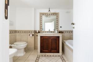 a bathroom with a toilet and a sink and a tub at La Terrazza del Marinaio in Ostuni +24 photos