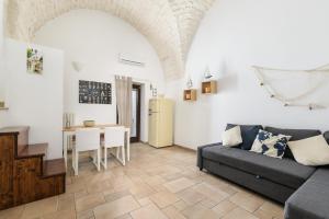 a living room with a couch and a table at La Terrazza del Marinaio in Ostuni