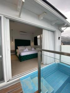 a balcony with a bed and a swimming pool at Qeparo Napolon Complex in Qeparo +128 photos