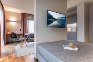 a hotel room with a bed and a living room with at ipartment Berlin Airport in Schönefeld