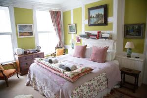 The Old Bakehouse, Walsingham في ليتل والشنغهام: غرفة نوم مع كلبين ملقين على سرير