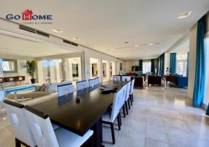 a large dining room with a long table and chairs at Stylish 5B Room MB04@ New Marina in Hurghada
