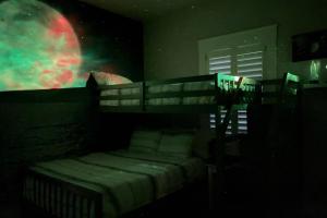 a bedroom with a bunk bed with a moon on the wall at Mojo's Dojo in McKinleyville