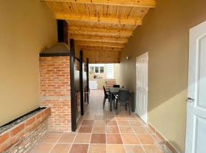 a hallway of a house with a table and chairs at Temporarios Roque Saenz Peña, Dto C in Puerto Madryn