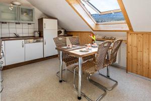 a kitchen with a table and chairs and a window at Haus Elfi in Hausen am Tann