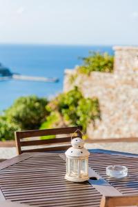 a lantern sitting on top of a wooden table at Villa Cavo d' Oro in Korissia